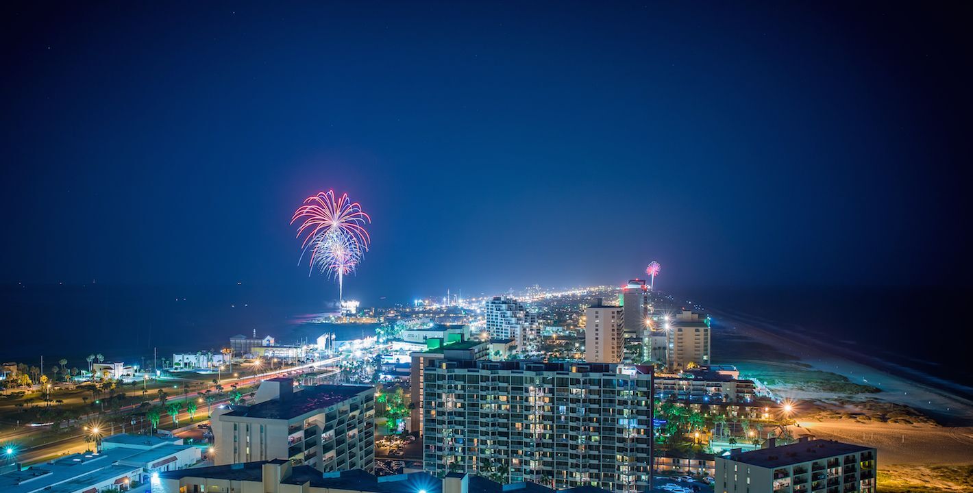 Fireworks over South Padre Island cityscape at night