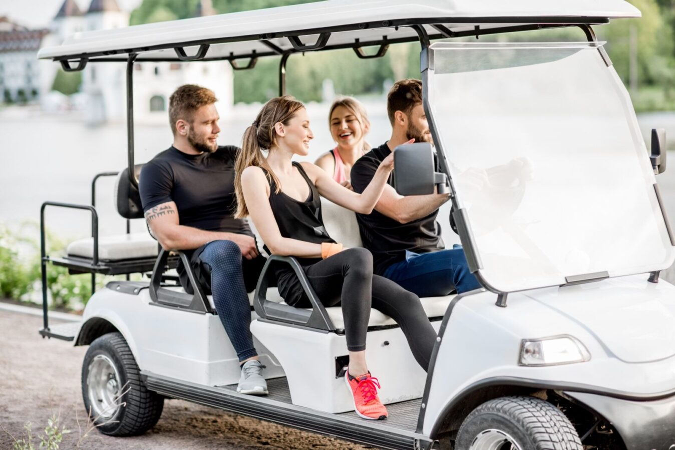 Group of friends in a golf cart.