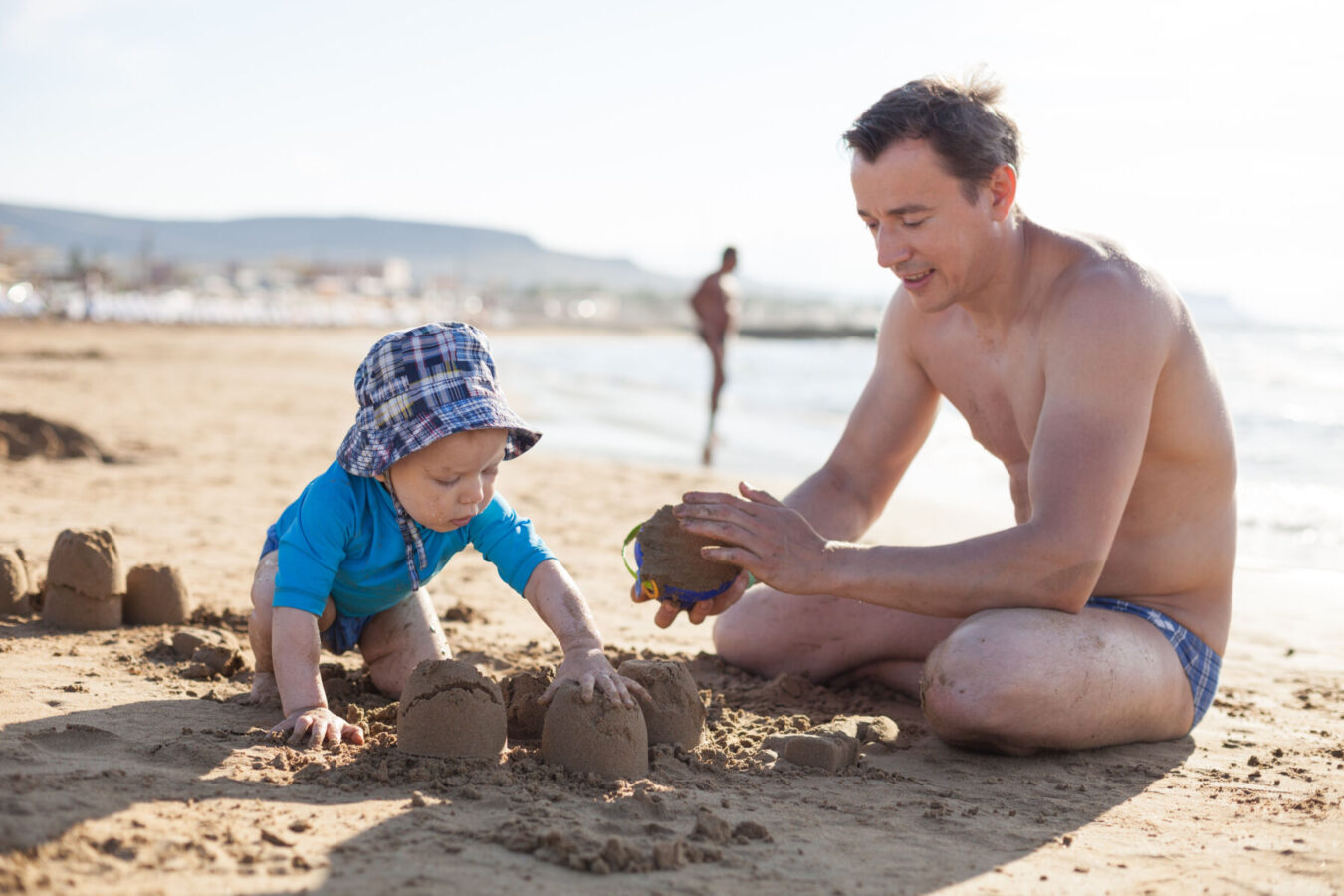 Father and son building sandcastle