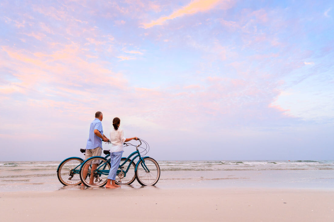 Sunset-bicycle-rides-on-South-Padre-Island | South Padre Island Vacation Rentals couple biking on SPI