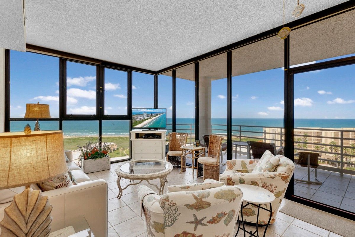 Spacious-condo-lounges-with-floor-to-ceiling-windows | South Padre Island Vacation Rentals living room overlooking ocean