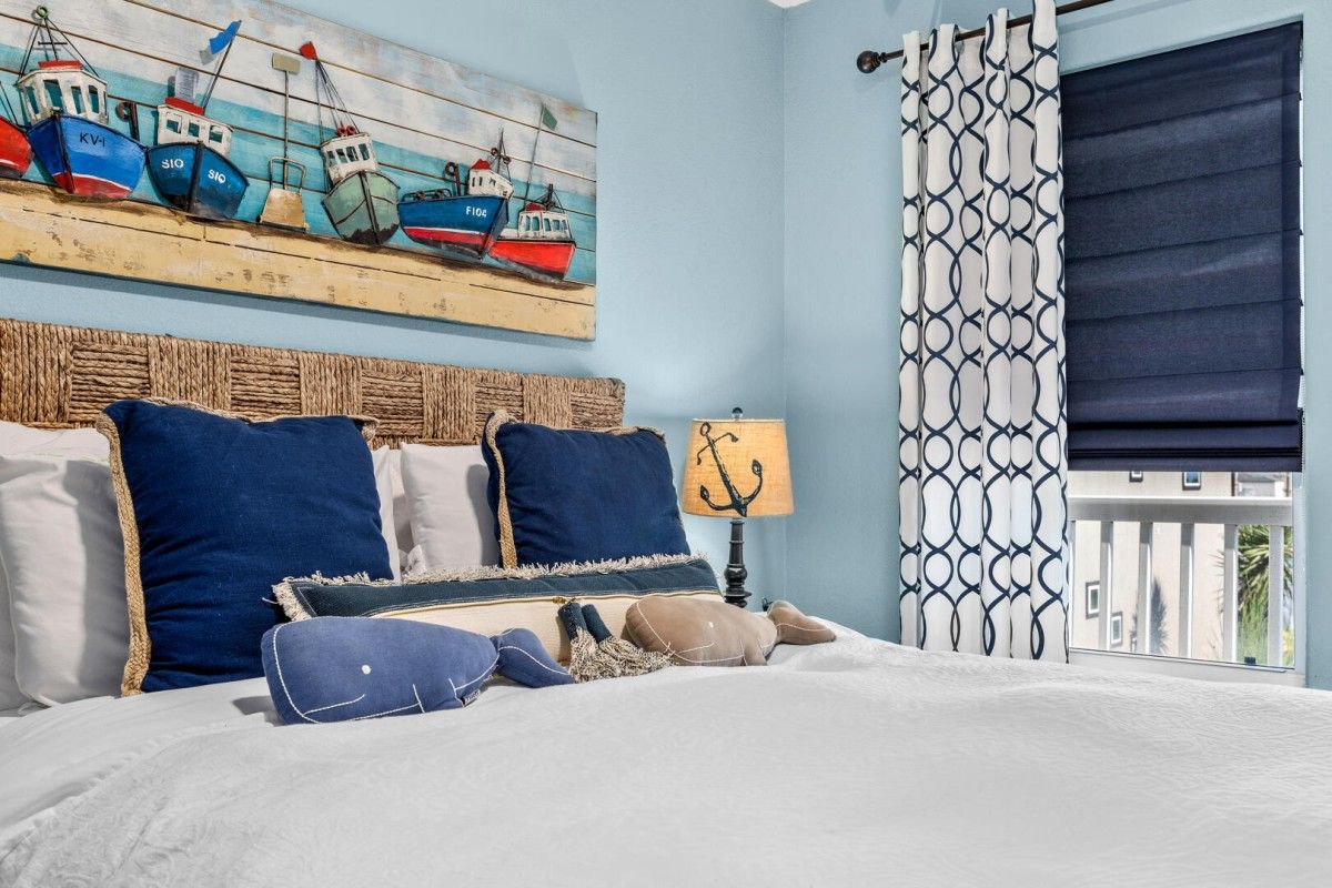 Master-bedroom-suites-with-coastal-bedding | South Padre Island Vacation Rentals bed with whale pillows